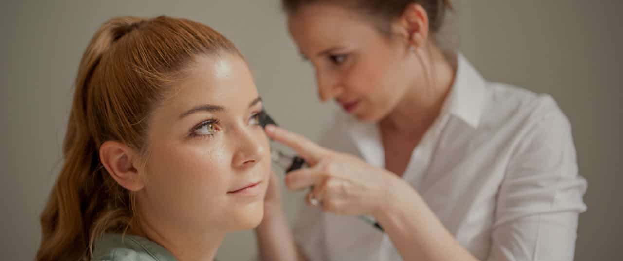 doctor examining female patient