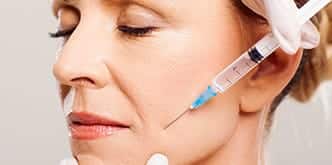 close-up image of a middle-aged woman receiving dermal filler treatment