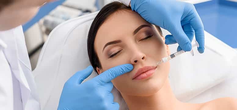 Close-up image of a woman at a dermatologist appointment, receiving dermal fillers